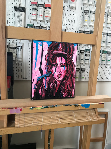 ‘AMY WINEHOUSE’ original painting. This original portrait is acrylic on 8x10” stretched canvas.  Artwork shown on my easel in my art studio.