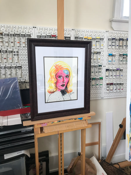 'BETTE DAVIS EYES' original painting. This original portrait is 11x14" acrylic on bristol. Painting is shown beautifully matted and framed.  Artwork is pictured on my easel in my art studio.