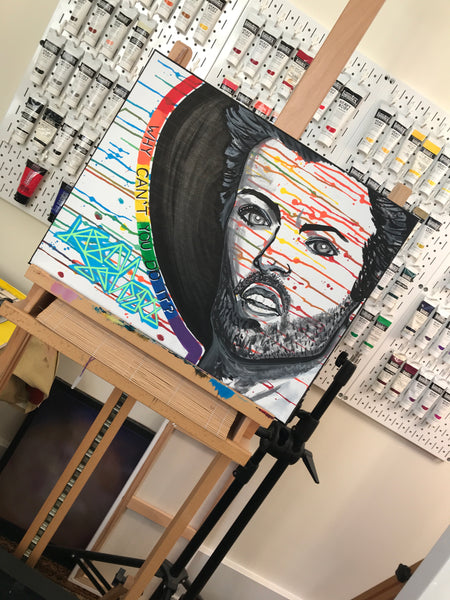This portrait features George Michael and was inspired by the music video for 'MONKEY'. This painting is 20x16" on a stretched canvas.  Artwork shown on my artist easel in my art studio.