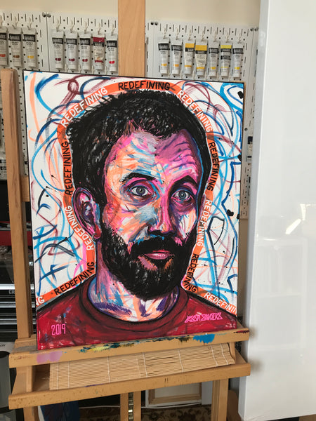This portrait features Joe Talbot of the band Idles and is titled ‘REDEFINING’. This original painting is acrylic on 16x20” stretched canvas. Artwork is shown on my easel in my art studio.